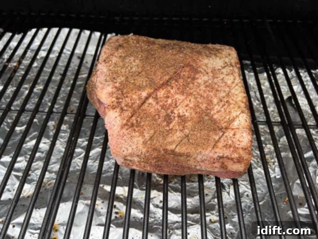 Succulent Traeger Smoked New York Strip Roast 9 A New York strip roast smoking on the grates of a Traeger pellet grill.