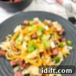 Classic Montreal Smoked Meat Hash 6 A plate with Montreal Smoked Meat Hash with strawberries in the background.