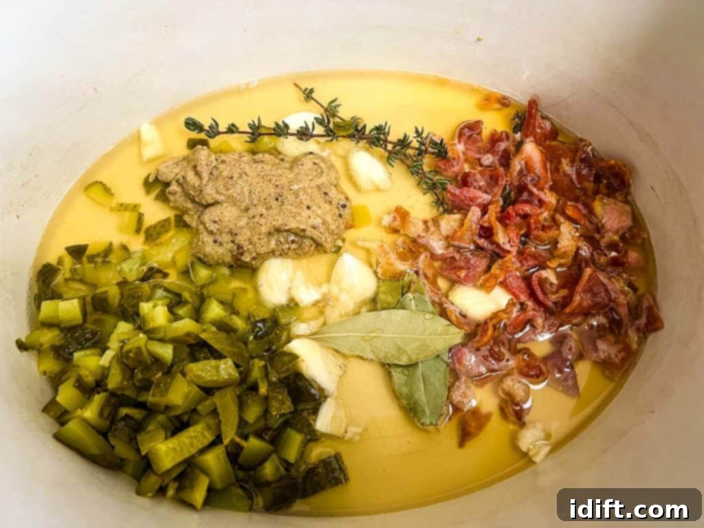 A slow cooker insert filled with the seared beef, bacon, sautéed onions, and spices, ready for the slow cooking process.