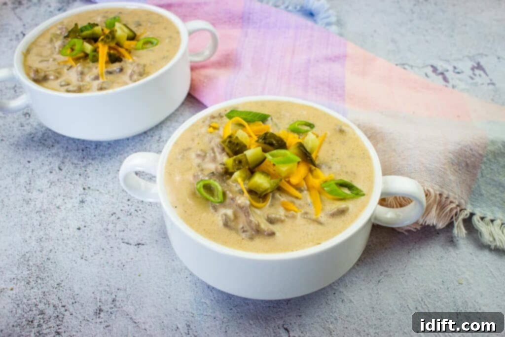 25 Low-Carb Recipes That Outshine the Classics 13 Cheeseburger soup in two serving bowls, garnished with fresh toppings.