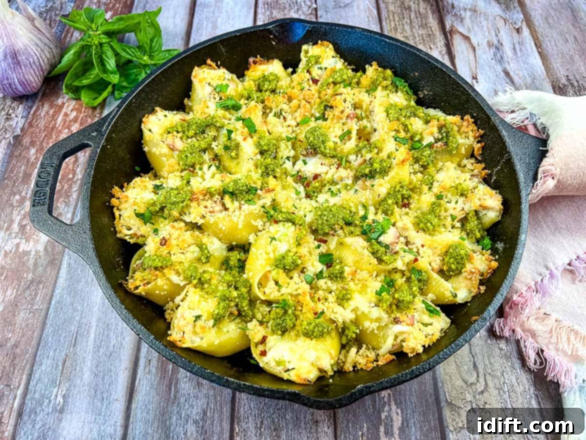 Turkey and Pesto Stuffed Pasta Shells in a black cast iron dish.