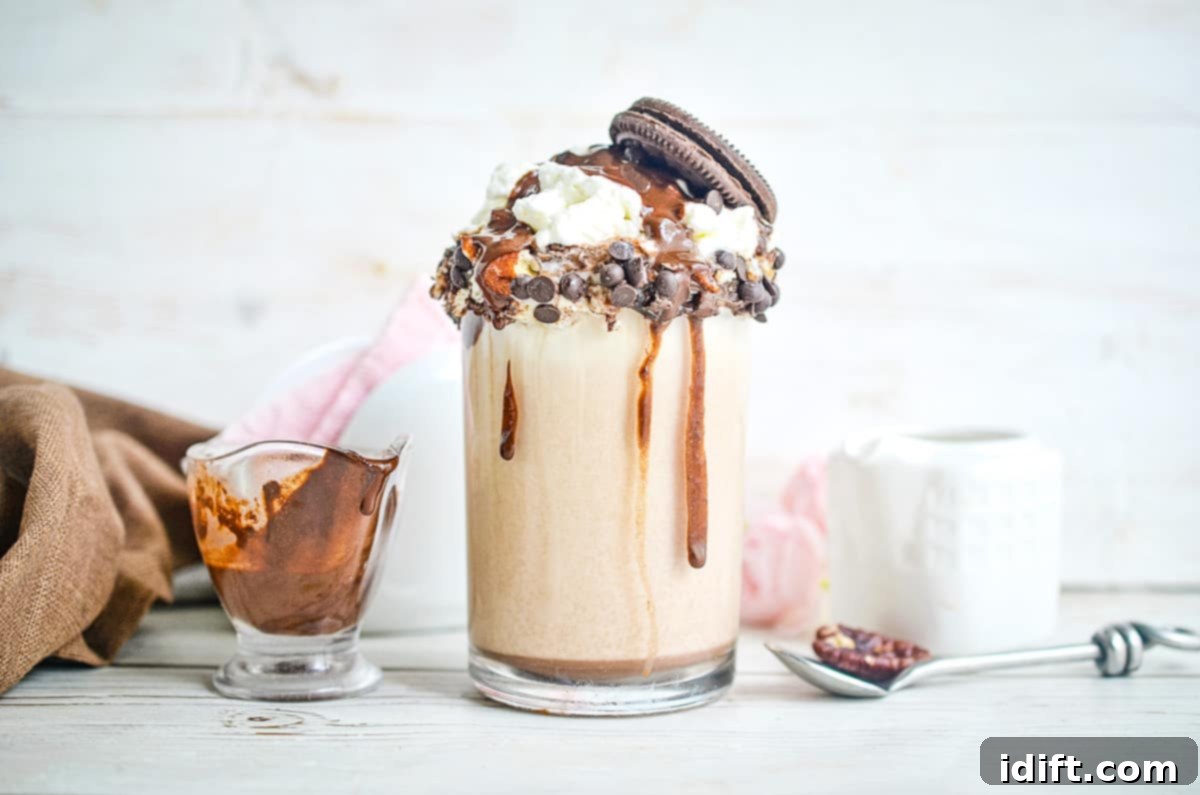 Dondurmayı Boş Verin: 19 Tatlı Lezzet 4 Cookie Dough Milkshake with a spoon and syrup in the background.