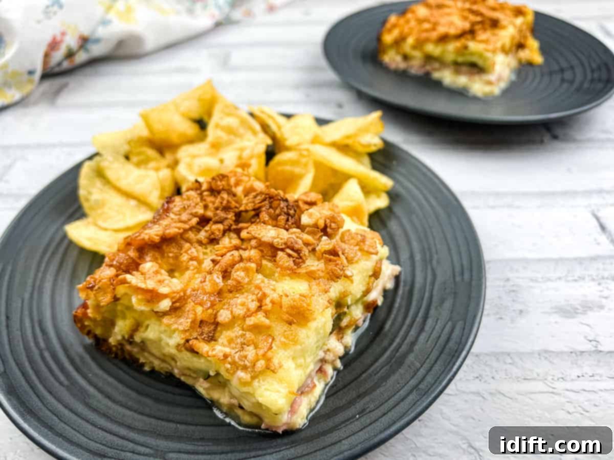 11 Brunch Masterpieces for a Triumphant Feast 4 A piece of Cuban sandwich casserole on a plate with potato chips.