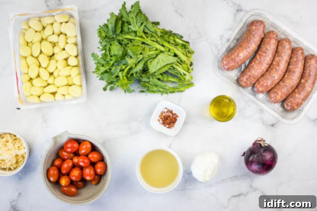 A curated selection of fresh ingredients including Italian sausage, broccoli rabe, cherry tomatoes, and gnocchi.