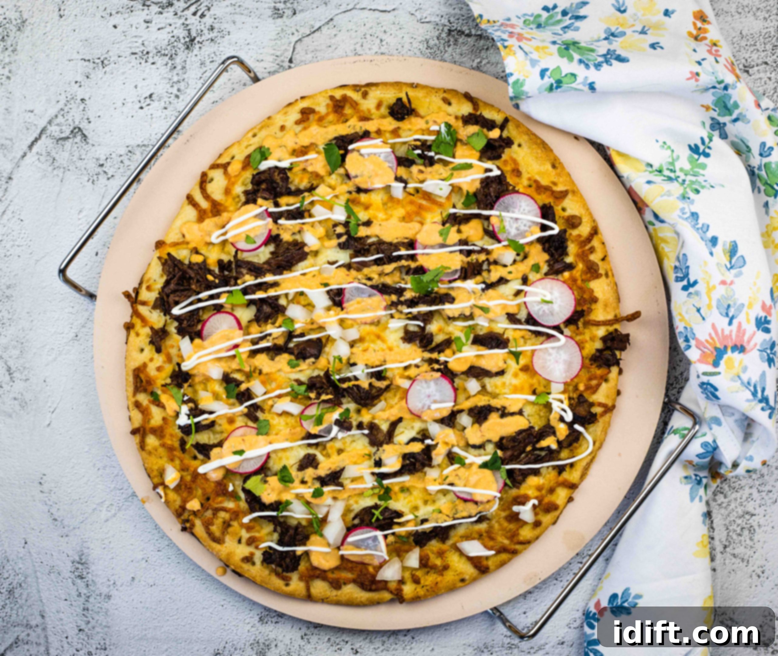 17 Prize Winning Beef Recipes 5 Birria Pizza on a pizza stone.
