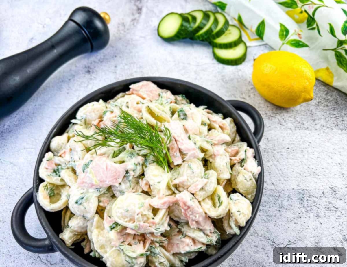 Your Fridge's Secret: 19 Leftover Transformations You'll Crave Again 2 Salmon pasta salad in a black bowl with forks nearby.