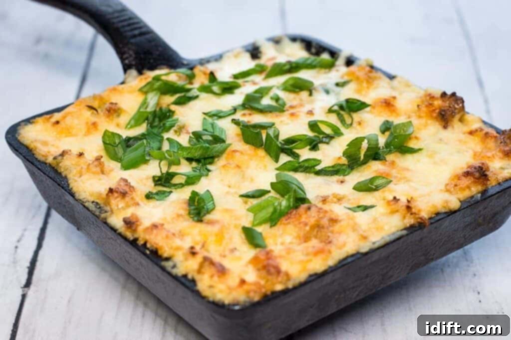 Cheesy potato casserole in a cast iron skillet.