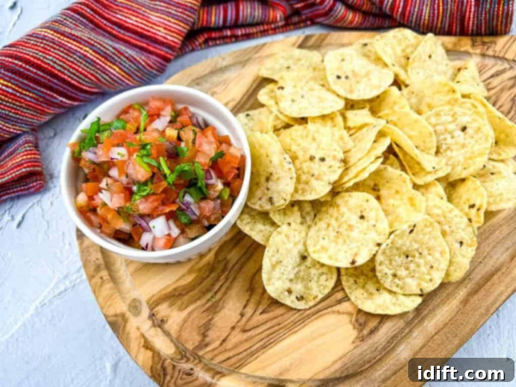 Recipes for serious snackers only - Mexican salsa and chips on a wooden cutting board.