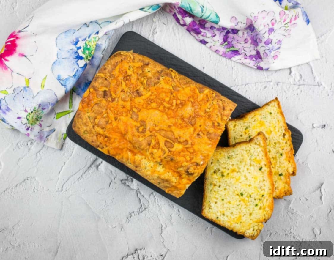 19 Ultimate Carb Feasts for Every Craving 7 A top-down shot of a beautifully baked Potato Cheese Bread with several slices cut, resting on a black platter.