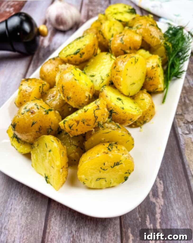 Ukrainian potatoes with dill on a white plate.