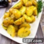 Ukrainian potatoes with dill on a white plate.