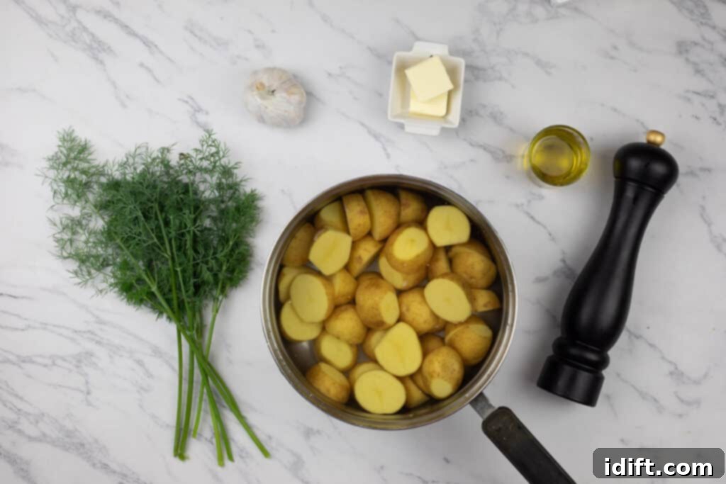 A pan with potatoes, butter and dill on a marble table.