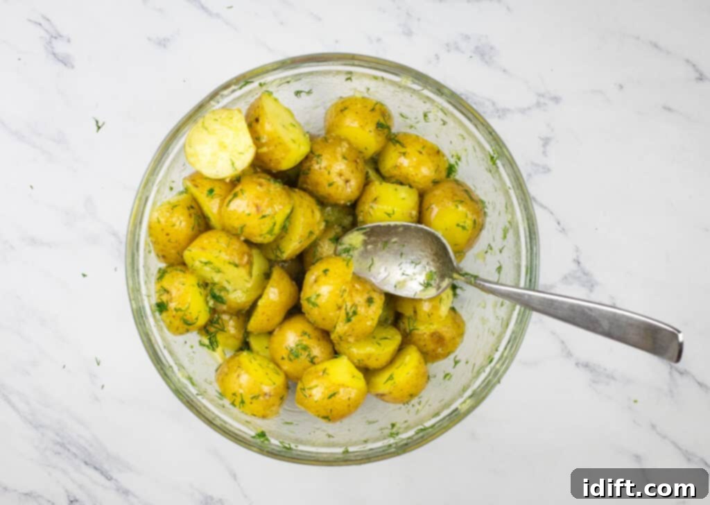 Potatoes in a glass bowl with a spoon.
