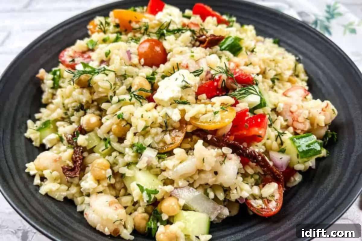 Fresh Start Meals 25 Recipes to Cook From Scratch 11 A bowl of Mediterranean orzo salad on a black plate.
