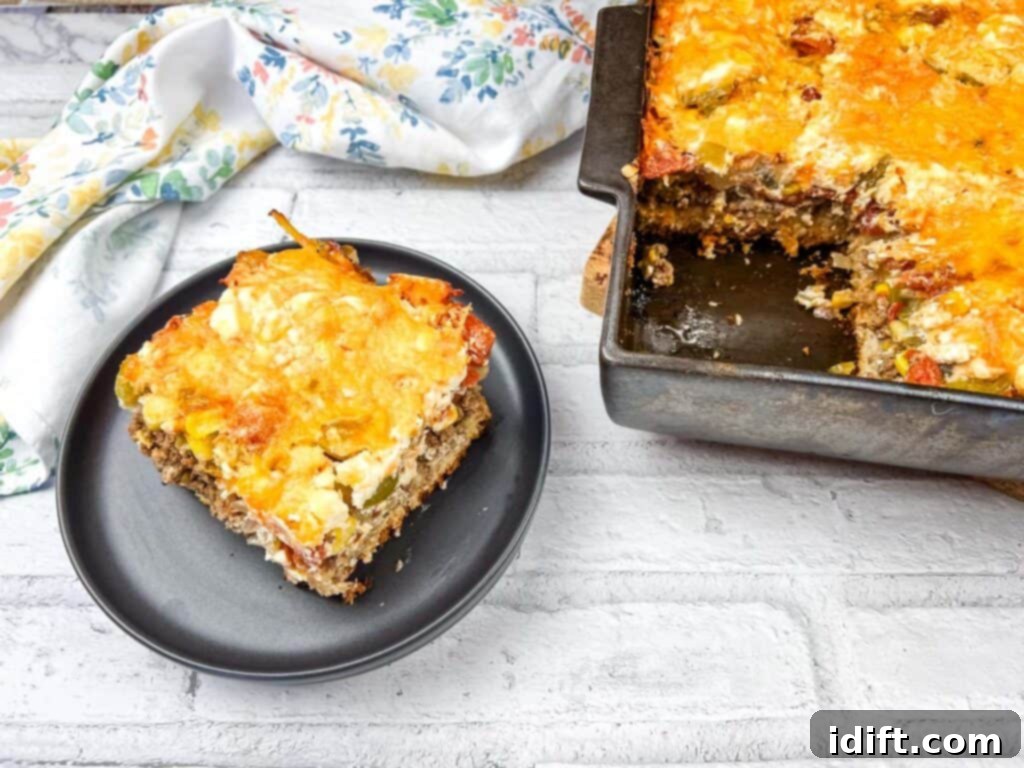 A delicious piece of John Wayne casserole on a white plate, ready to be enjoyed.