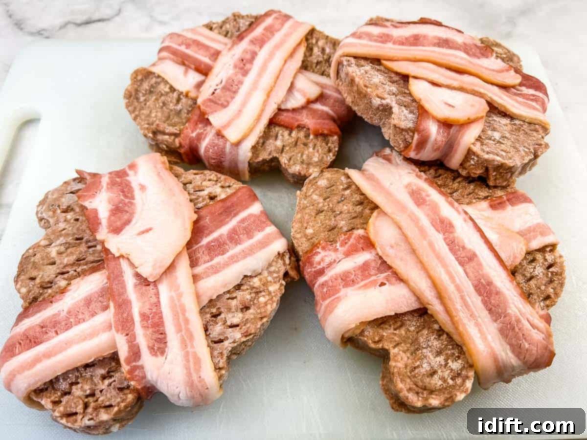 Bacon-Wrapped Burger on a black plate.