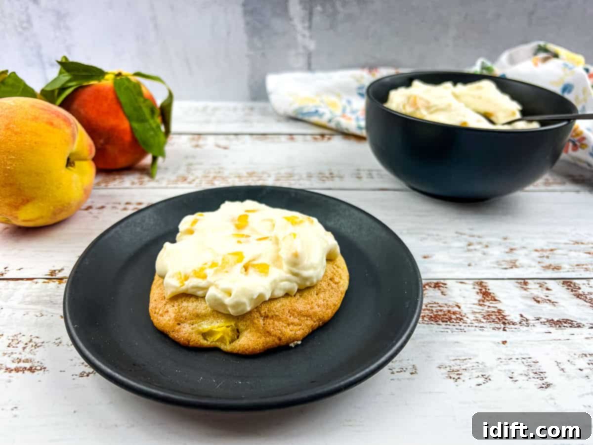 Fresh Peaches & Cream Cookies served on a white plate, with whole peaches nestled nearby.