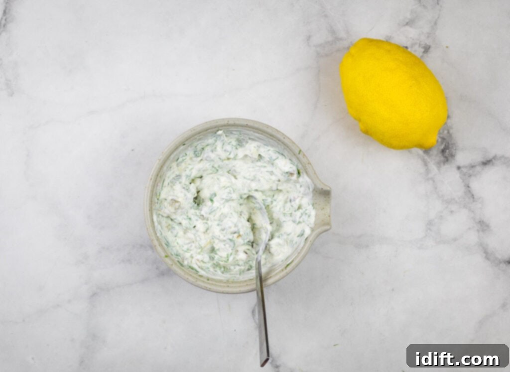 A bowl with a spoon and lemon next to it.