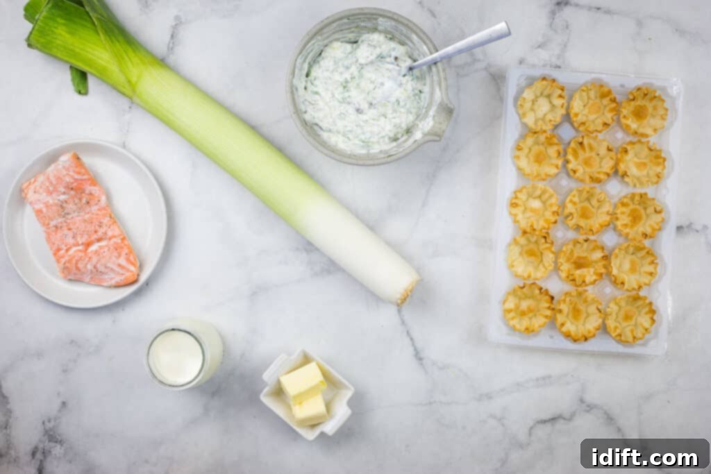 The ingredients for a salmon and leek tartare are laid out on a marble table.