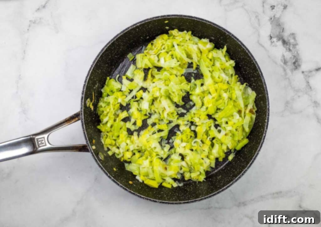 A frying pan filled with chopped leeks.