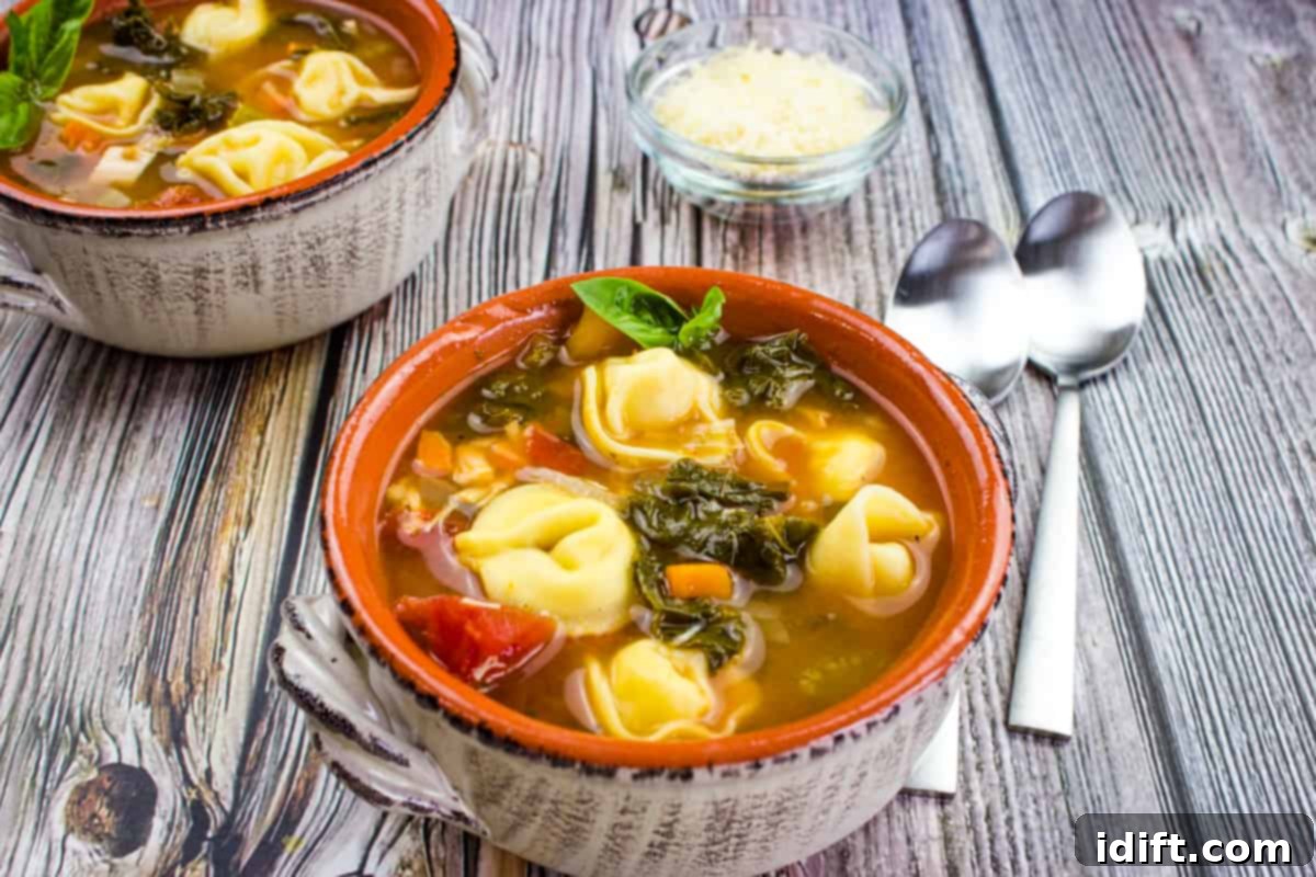 Dinner Done Right 13 Foolproof Chicken Recipes 7 Kale and tortellini soup in a bowl on a wooden table.