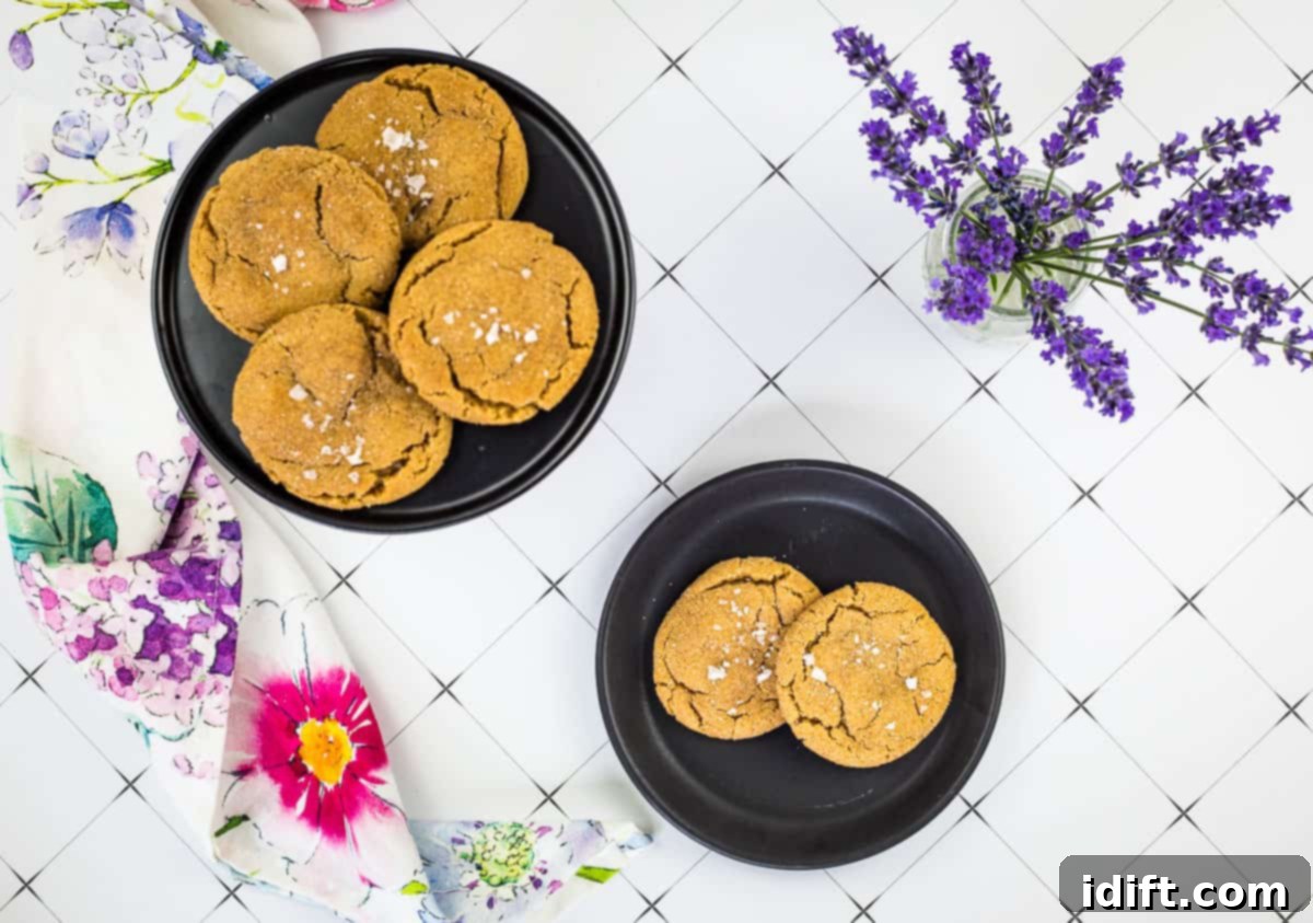 Two bowls of salted caramel snickerdoodle cookies on a plate with lavender flowers on the table.