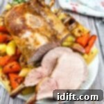 Roasted pork with carrots and potatoes on a plate.