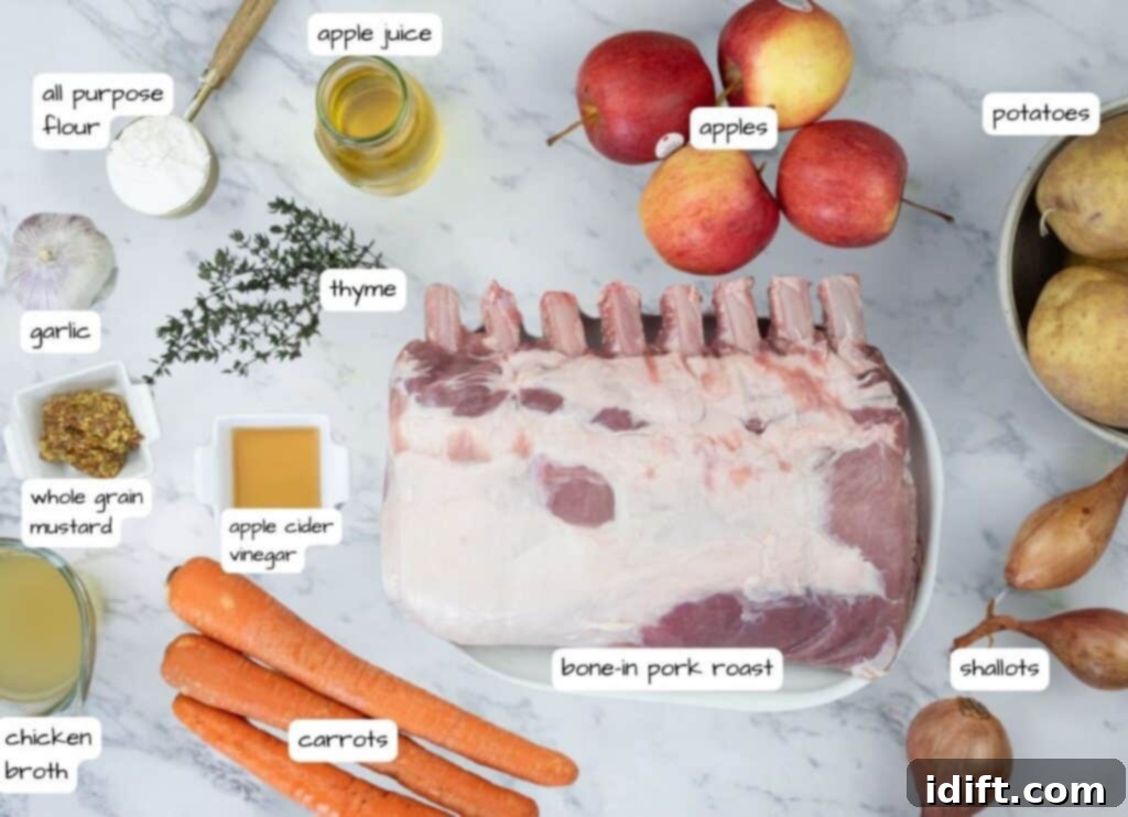A vibrant display of fresh ingredients for a pork roast: a bone-in pork loin, crisp apples, colorful carrots, potatoes, shallots, garlic, thyme, chicken broth, apple juice, whole grain mustard, apple cider vinegar, and butter.