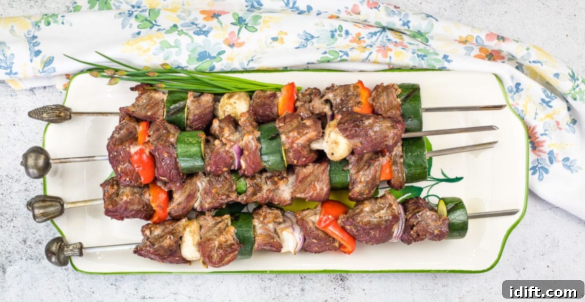 Smoked beef kabobs on a plate.