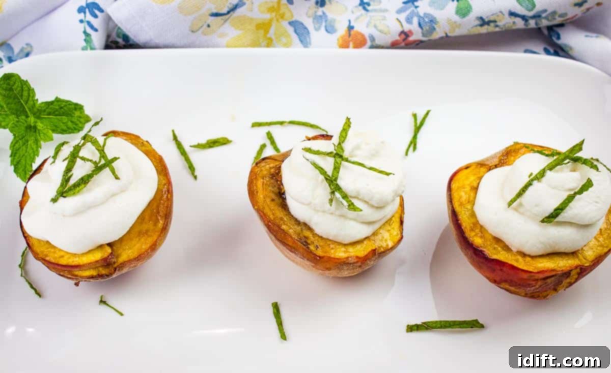 Smoked peaches topped with spiced rum whipped cream on a platter.