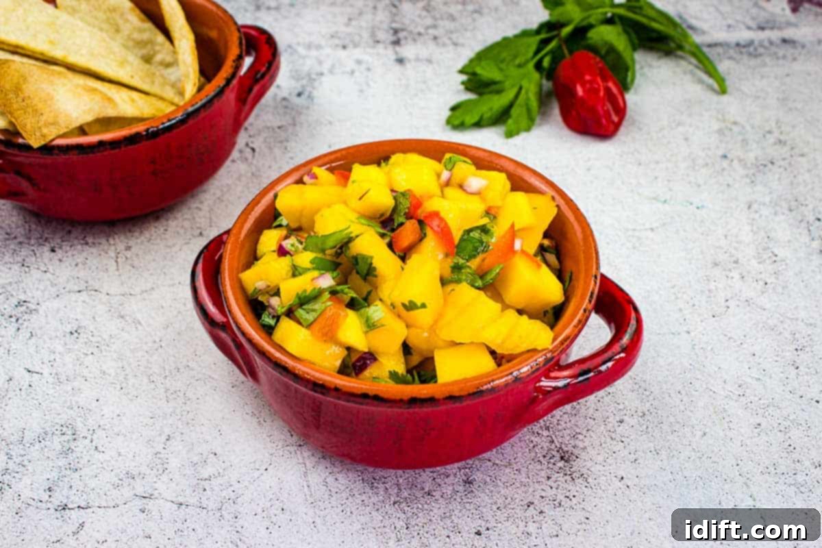 11 Recipes to Ignite Your Spice Obsession 2 Mango Salsa in a bowl with chips nearby.