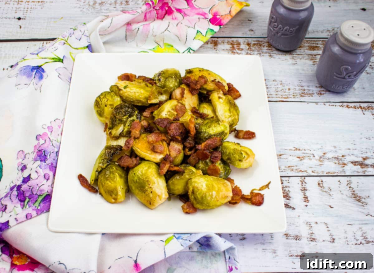 Smoked Brussels Sprouts with crispy bacon bits on a white plate, showcasing a beautiful char.