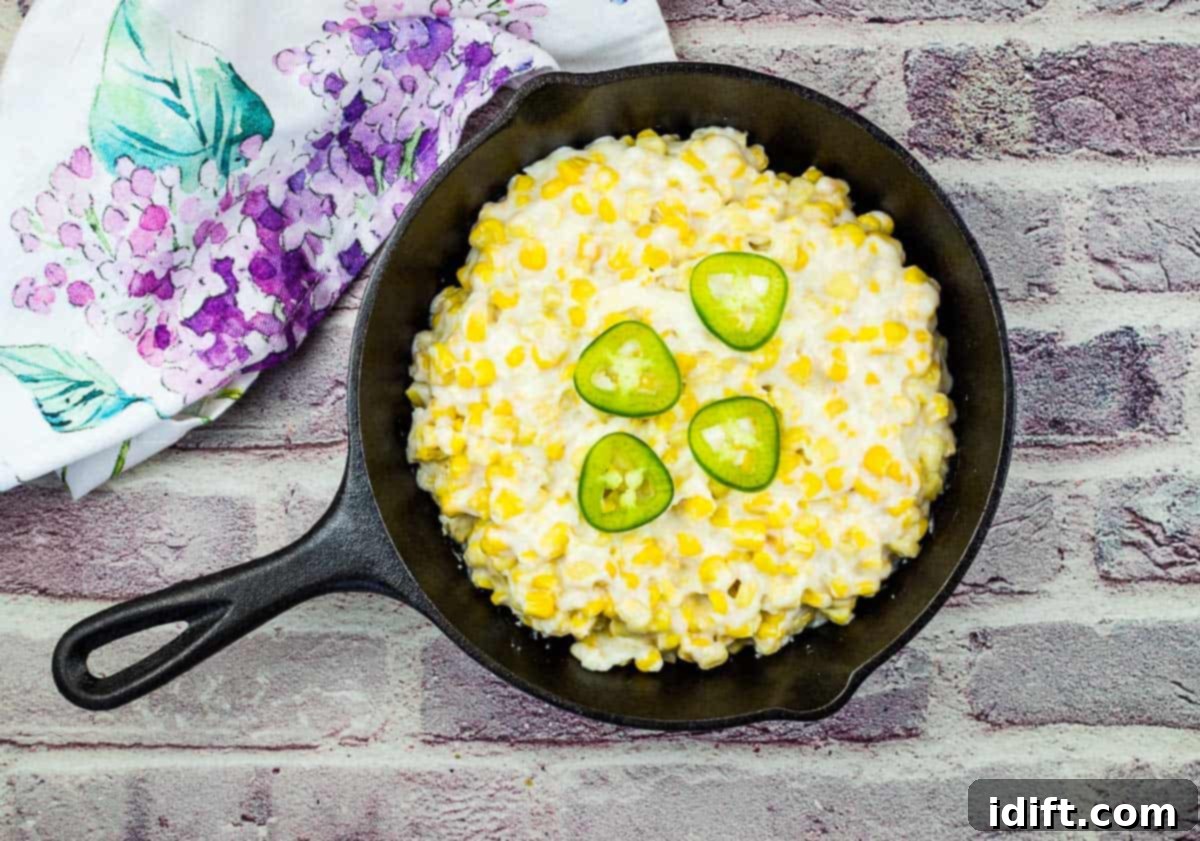 Smoked Creamed Corn in a black skillet, rich and golden.