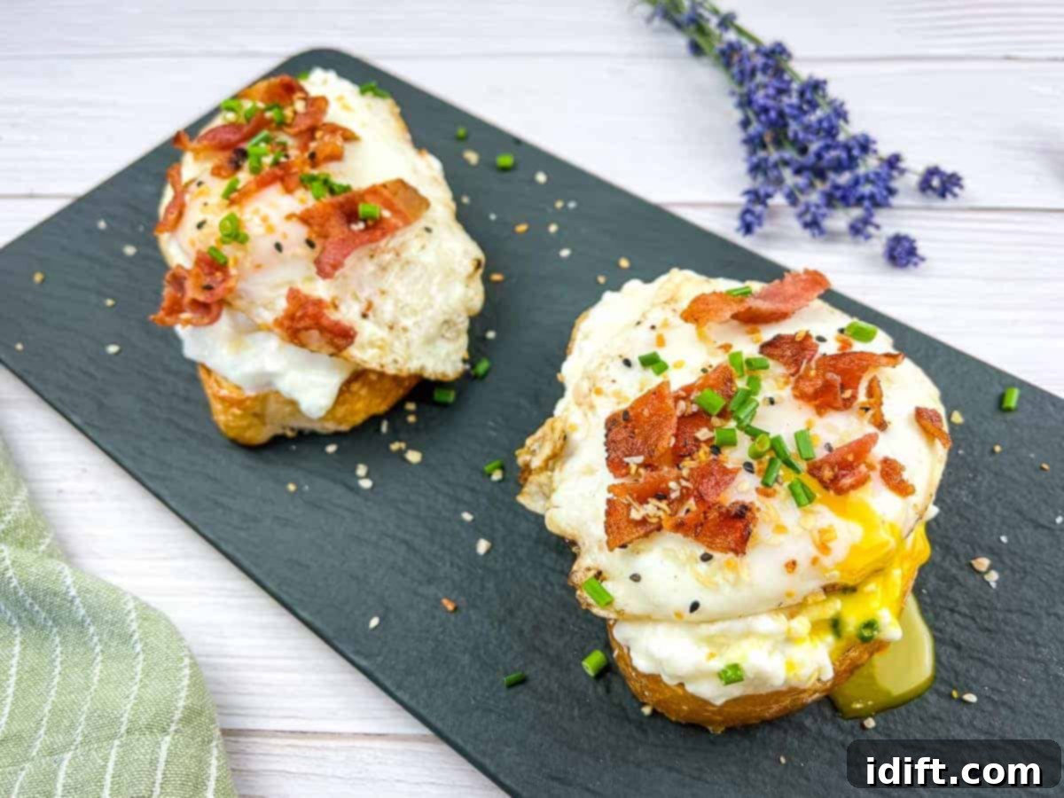 17 Heartwarming Comfort Foods Straight From Grandmas Kitchen 7 Two slices of Cottage Cheese Toast with Eggs & Bacon on a black platter.