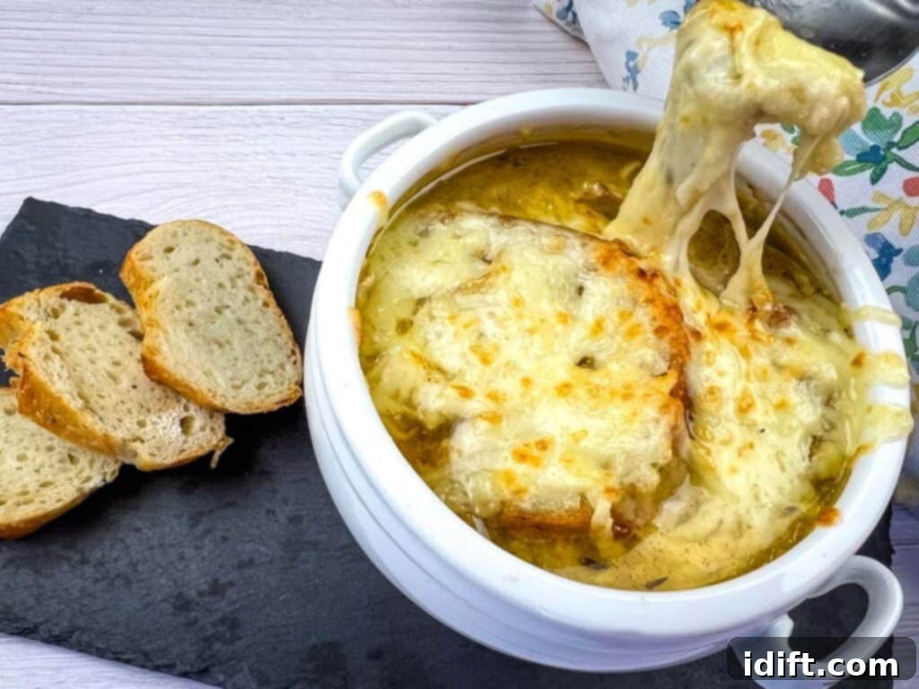 Chef Jenn's Signature French Onion Soup 10 A bowl of cheesy soup with bread on top, perfectly broiled and ready to serve.