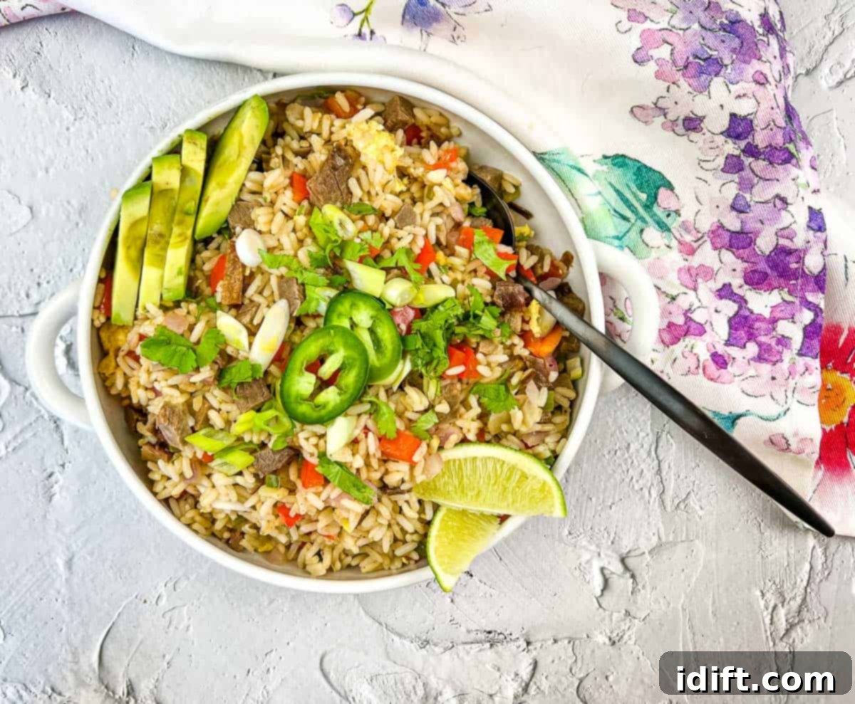19 Leftover Dishes You'll Seriously Crave 4 Brisket fried rice in black serving dish on white background.