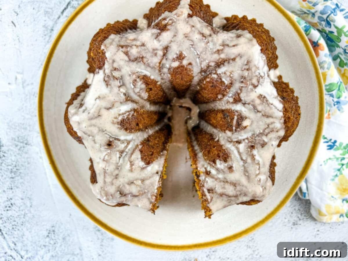 21 Quick & Easy Sweet Treats 12 A rich Pumpkin Chocolate Cake served on a white circular plate with an elegant gold rim.