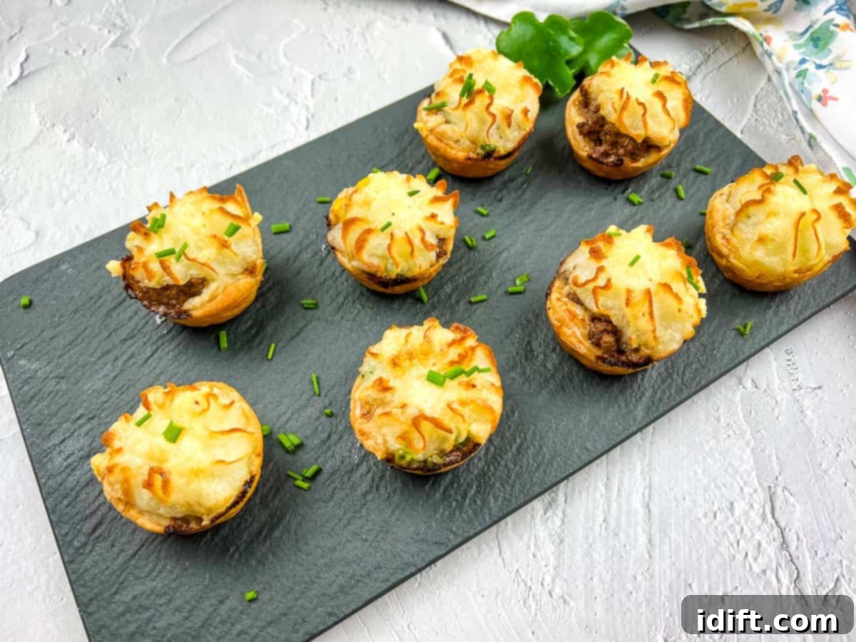 13 Irish-ish Delights Perfect for a Pint 4 Shepherd's Pie Bites on a black platter.