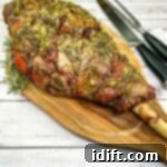 A smoked leg of lamb on a wooden cutting board.