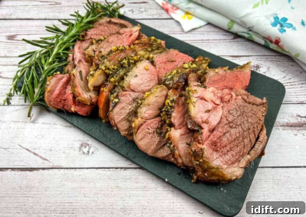 Succulent slices of smoked lamb garnished with fresh rosemary and thyme, served on a natural wooden board.
