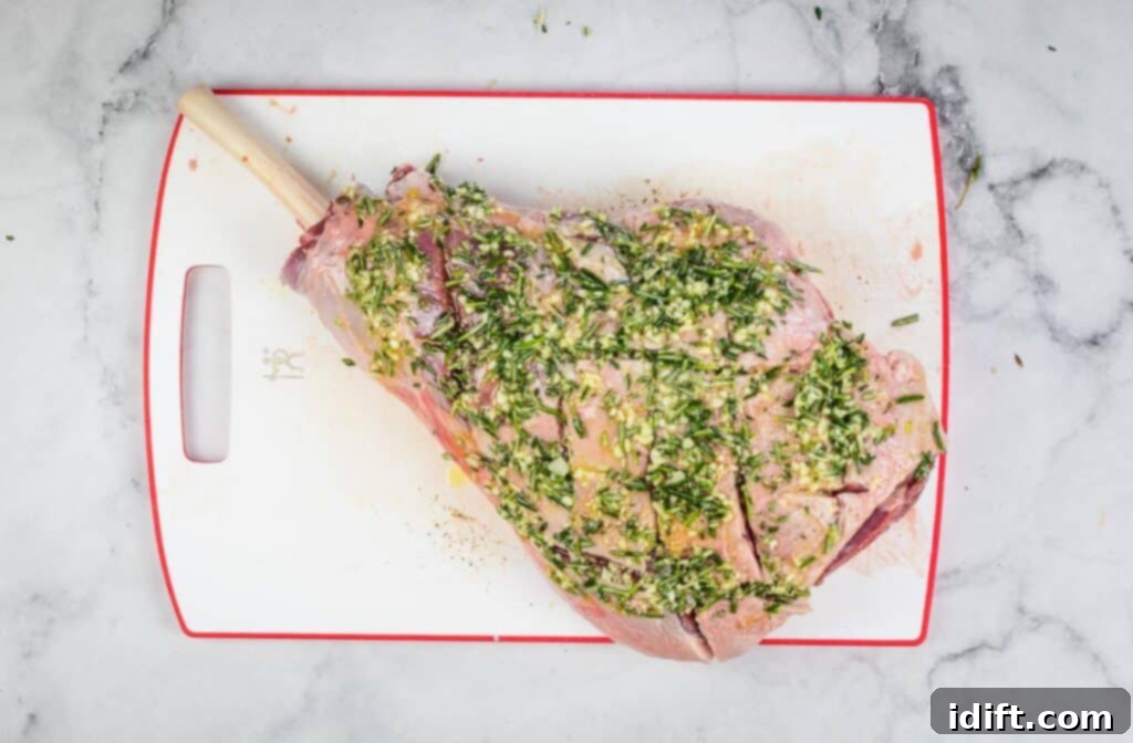 A leg of lamb thoroughly coated with a fragrant herb and garlic paste, ready for smoking.