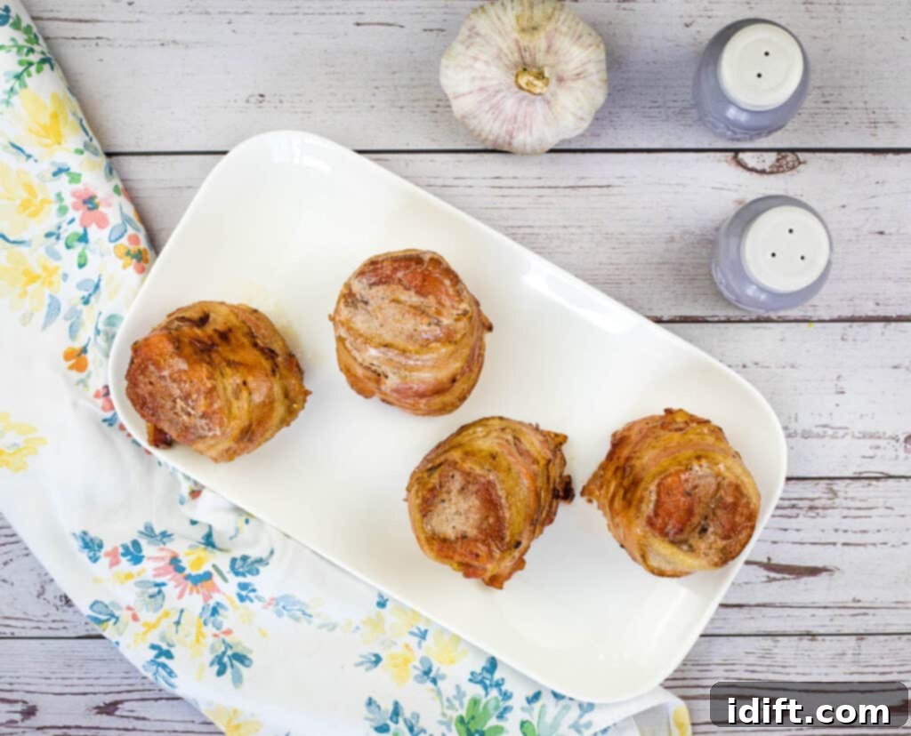smoked bacon wrapped pork tenderloin on a plate