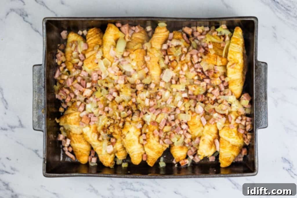 Fluffy Croissant Breakfast Delight 7 A baking pan filled with ham and onions.