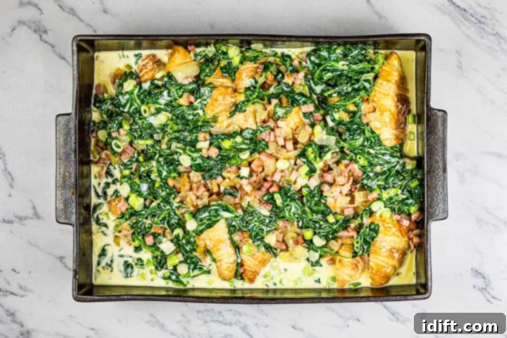 Fluffy Croissant Breakfast Delight 8 A baking dish with spinach and egg in it.