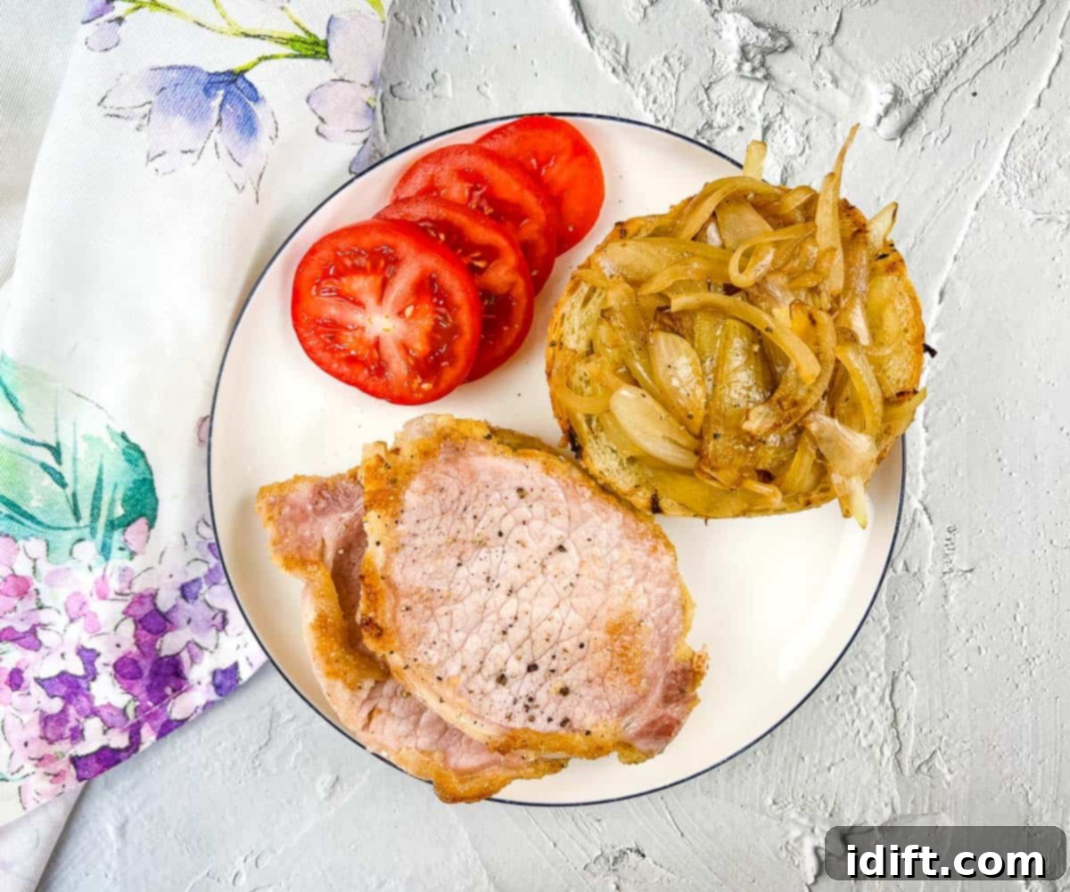 From Grandma's Table: 13 Beloved Recipes That Never Go Out of Style 3 Peameal bacon, sliced and pan-fried, served on a plate with fresh tomatoes and onions, embodying classic home cooking.