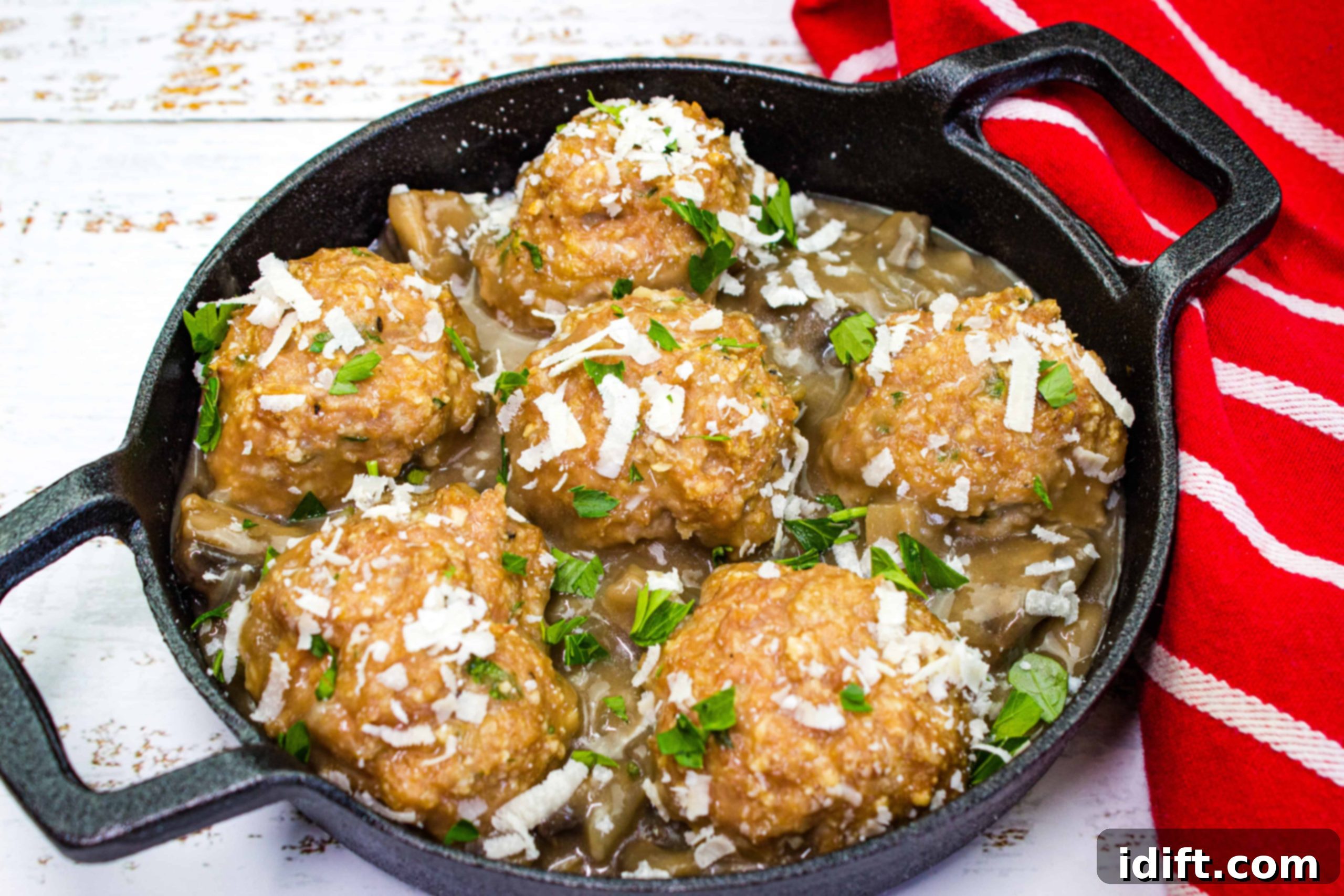 Healthy Eating Made Easy 17 Tempting Chicken Dishes 5 Rich Chicken Marsala Meatballs presented in a dark ceramic dish, garnished with fresh parsley.
