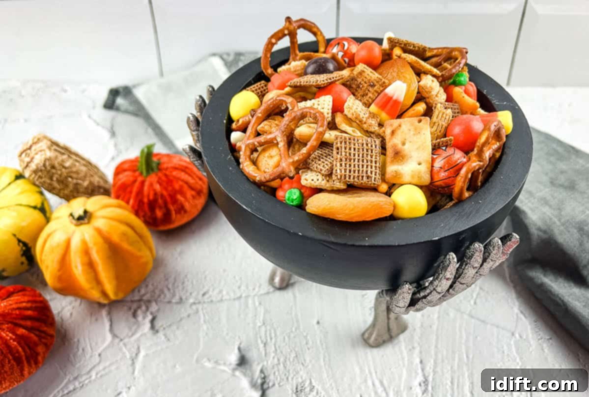 Spicy Chex Mix overflowing in a festive bowl, with hints of Halloween candies suggesting a fun, adventurous snack.