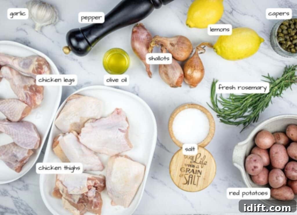 A curated display of ingredients for a lemon-rosemary chicken recipe, neatly arranged on a white marble table.