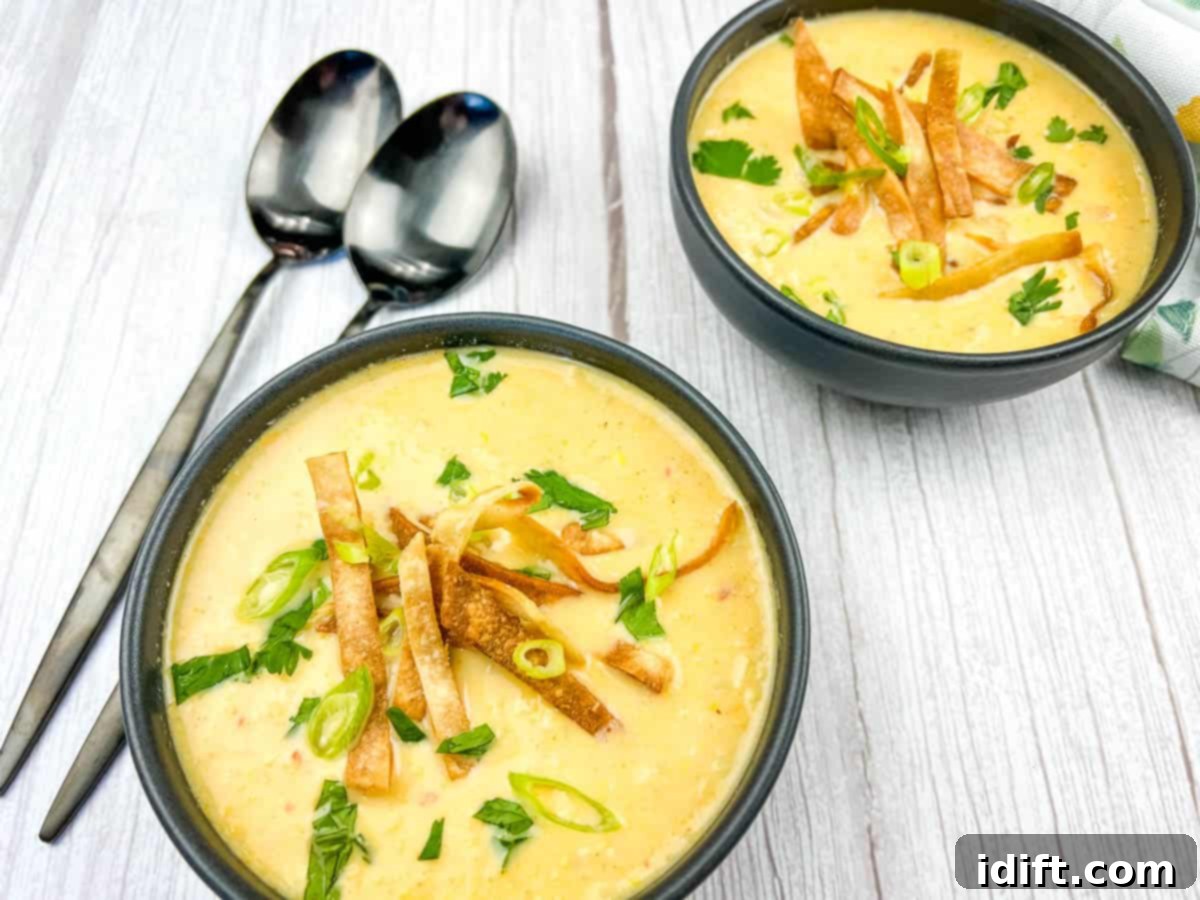 13 Easy Dinners That Taste Gourmet 2 A vibrant bowl of Mexican street style corn soup, garnished with fresh herbs, served on a white plate.