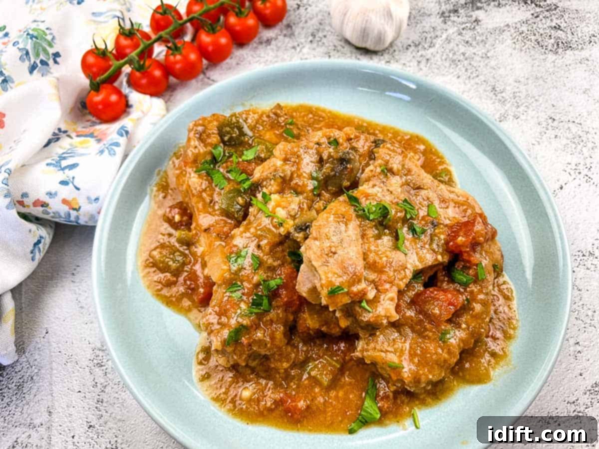 Slow Cooker Swiss Pork Chops on a baby blue serving dish.